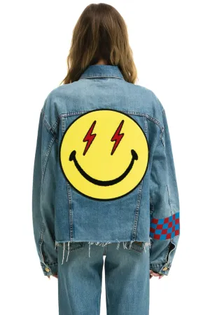 AVIATOR NATION STOKED BOLT SMILEY OVERSIZED CUTOFF DENIM JACKET - VINTAGE